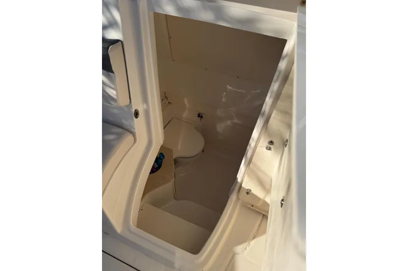 Slide: The Image of 2017 Robalo R302 Center Console interior cabin with seating and storage. - 9