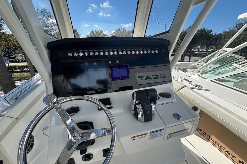Slide: The Image of 2026 World Cat 265 CC-X boat dashboard with steering wheel and control panel. - 6