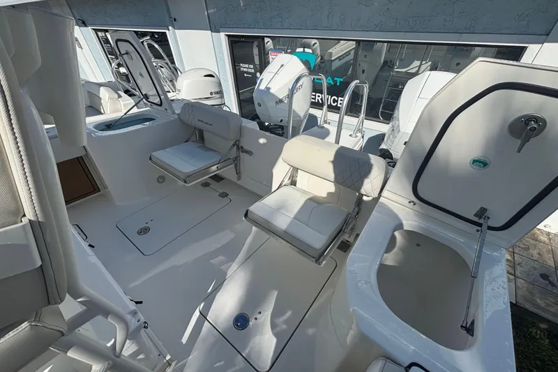 Slide: The Image of Interior view of 2026 World Cat 265 CC-X boat, featuring seating and storage compartments. - 8