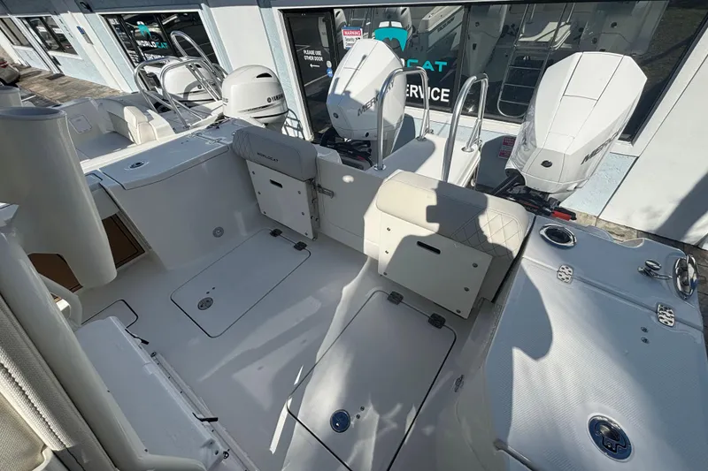 Slide: The Image of 2026 World Cat 265 CC-X boat interior with dual outboard motors, spacious deck, and seating. - 9