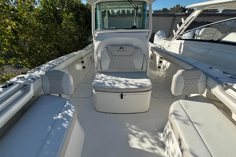 Slide: The Image of 2025 World Cat 325 CC boat interior with white seating and modern design. - 10