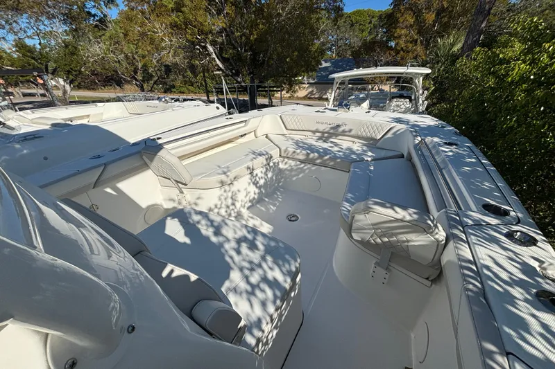 Slide: The Image of 2025 World Cat 325 CC boat with spacious seating and sleek design in a natural setting. - 12