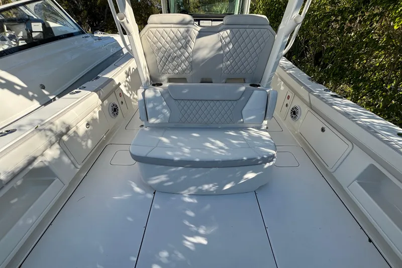Slide: The Image of 2025 World Cat 325 CC boat interior with cushioned seating and sleek design. - 15