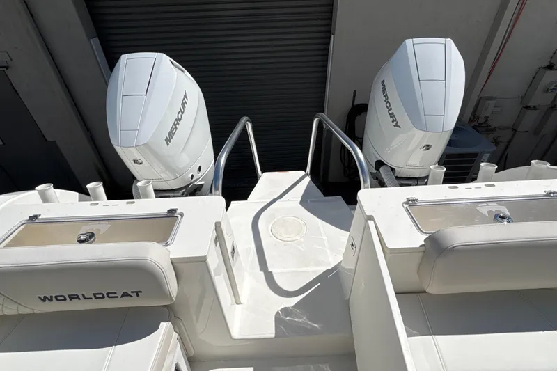Slide: The Image of 2025 World Cat 325 CC boat with dual Mercury engines, rear view. - 18