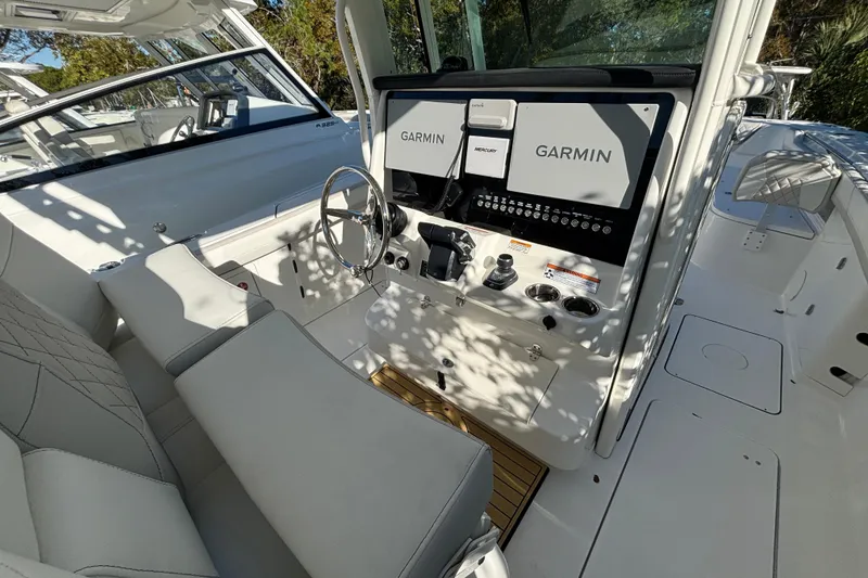 Slide: The Image of 2025 World Cat 325 CC boat cockpit with Garmin navigation system and luxurious seating. - 3