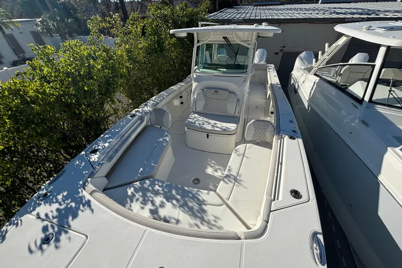Slide: The Image of 2025 World Cat 325 CC boat with spacious seating and sleek design, docked outdoors. - 9