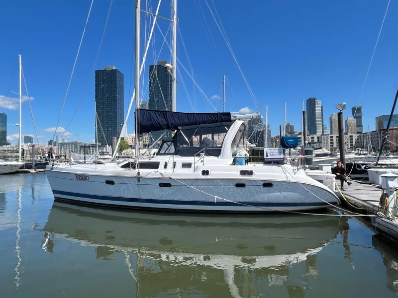 The Image of Sailboat docked in marina, 1999 Hunter Passage 450, with city skyline in background. - 0