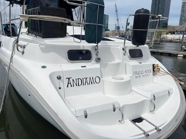 Slide: The Image of 1999 Hunter Passage 450 sailboat docked at marina, featuring "Andiamo" and "Paulus Hook, New Jersey" text. - 2