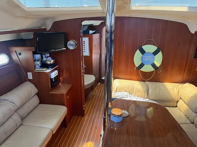 Slide: The Image of Interior of 1999 Hunter Passage 450 yacht with cozy seating and wooden finishes. - 5