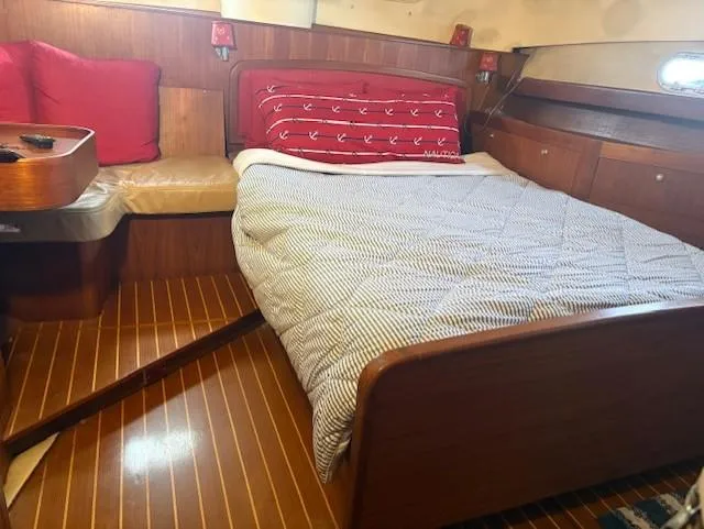 Slide: The Image of Cozy cabin interior of 1999 Hunter Passage 450 yacht with bed and wooden furnishings. - 7