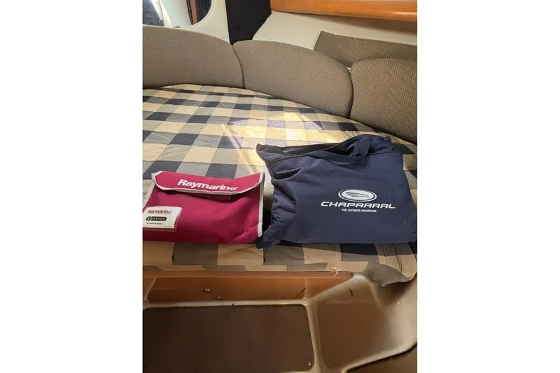 Slide: The Image of 2006 Chaparral Signature 310 cabin with Raymarine and Chaparral branded bags on bed. - 10