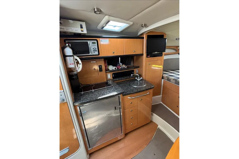 Slide: The Image of 2006 Chaparral Signature 310 interior with kitchenette, microwave, and TV. - 11