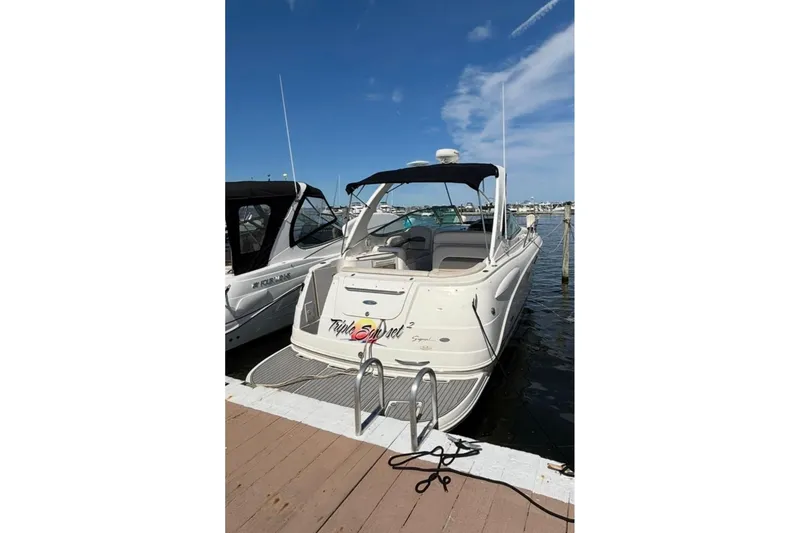 Slide: The Image of 2006 Chaparral Signature 310 boat docked at marina under clear blue sky. - 2