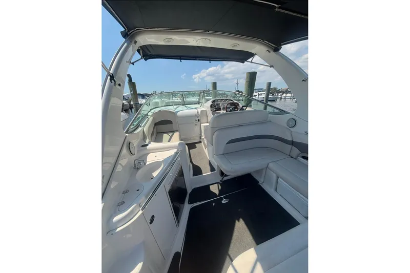 Slide: The Image of 2006 Chaparral Signature 310 boat interior with seating and helm, docked at marina. - 3