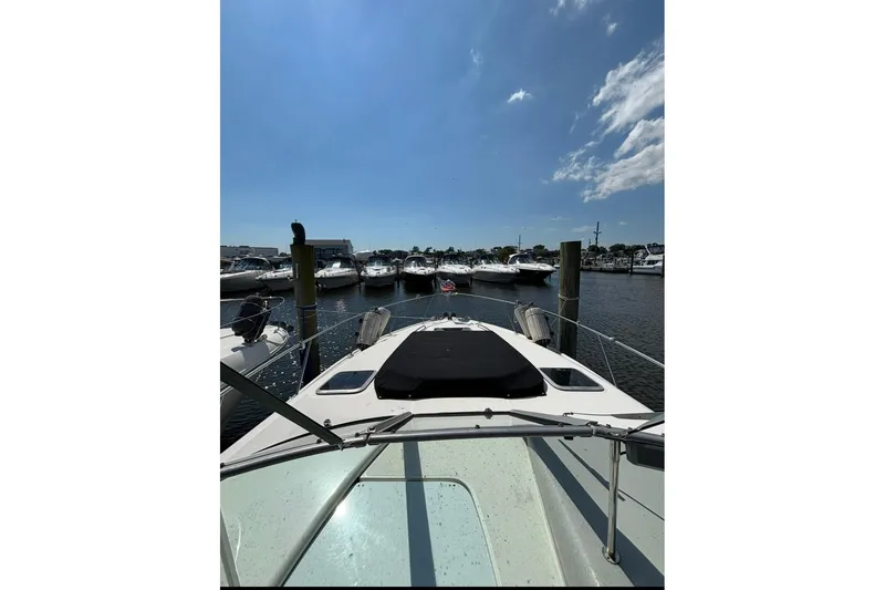 Slide: The Image of 2006 Chaparral Signature 310 yacht docked at a marina under a clear blue sky. - 7