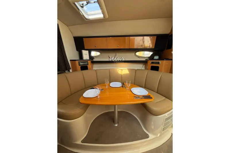 Slide: The Image of Interior of 2006 Chaparral Signature 310 yacht with cozy dining area and elegant decor. - 9