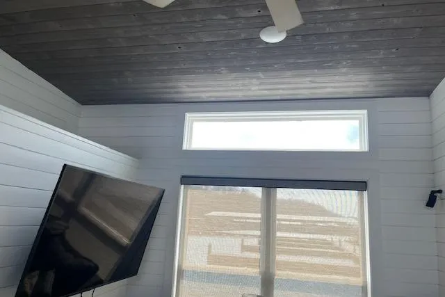 Slide: The Image of Modern cottage interior with TV and large window. - 17