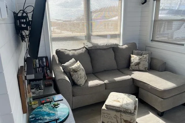 Slide: The Image of Cozy living room in 2021 Harbor Cottage with sectional sofa and decorative pillows. - 2