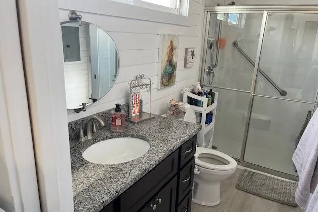 Slide: The Image of Modern bathroom in 2021 Harbor Cottage, featuring granite countertop and glass shower enclosure. - 21