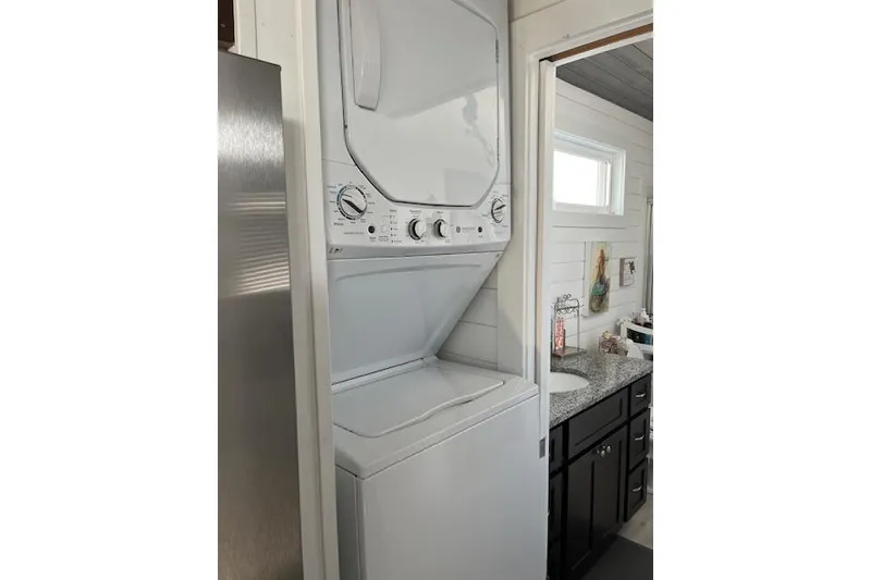 Slide: The Image of Stacked washer and dryer in a modern Harbor Cottage interior, 2021 model. - 23