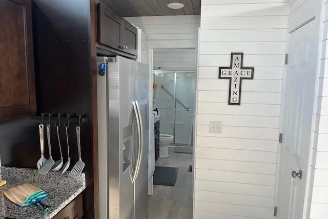 Slide: The Image of Modern kitchen in 2021 Harbor Cottage, featuring stainless steel appliances and white shiplap walls. - 24