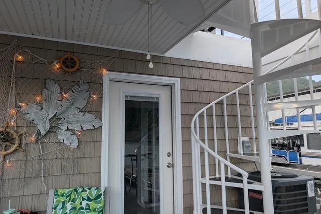 Slide: The Image of Cozy Harbor Cottage 2021 model with spiral staircase and decorative wall accents. - 28