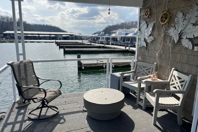 Slide: The Image of Cozy Harbor Cottage deck overlooking marina, featuring chairs and a table, 2021 model. - 31