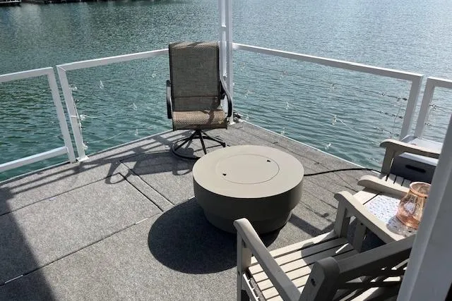 Slide: The Image of Rooftop deck of 2021 Harbor Cottage, featuring chairs and table overlooking serene water. - 35