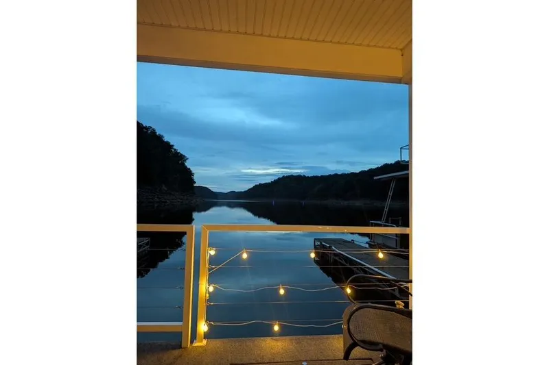 Slide: The Image of Cozy Harbor Cottage porch with string lights overlooking serene lake at dusk, 2021 model. - 37