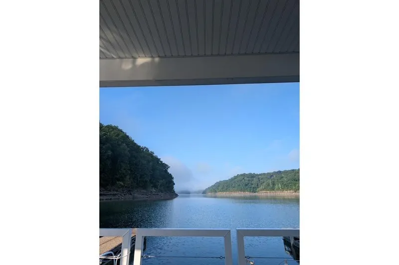 Slide: The Image of View from a 2021 Harbor Cottage, overlooking a serene lake and lush green hills. - 39