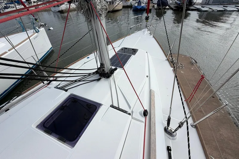 Slide: The Image of 2018 Jeanneau Sun Odyssey 389 sailboat deck with rigging in marina. - 10