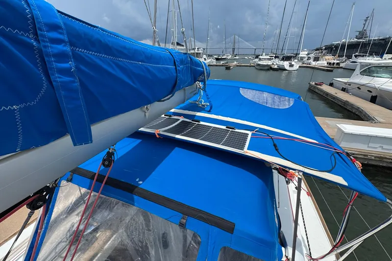 Slide: The Image of 2018 Jeanneau Sun Odyssey 389 sailboat with blue cover and solar panel at marina. - 14