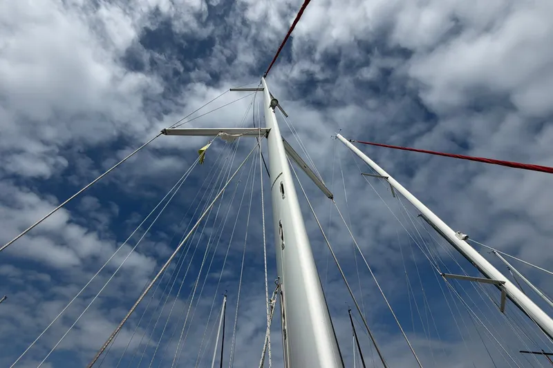Slide: The Image of Mast of 2018 Jeanneau Sun Odyssey 389 sailboat against a cloudy sky. - 17