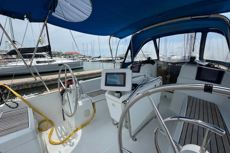 Slide: The Image of 2018 Jeanneau Sun Odyssey 389 sailboat cockpit with dual steering wheels and navigation equipment. - 20