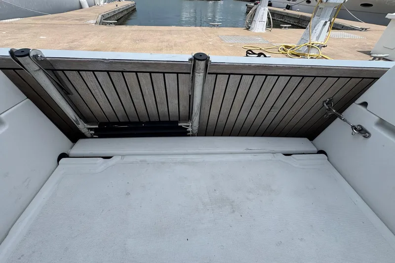 Slide: The Image of 2018 Jeanneau Sun Odyssey 389 swim platform with wooden finish at marina. - 23