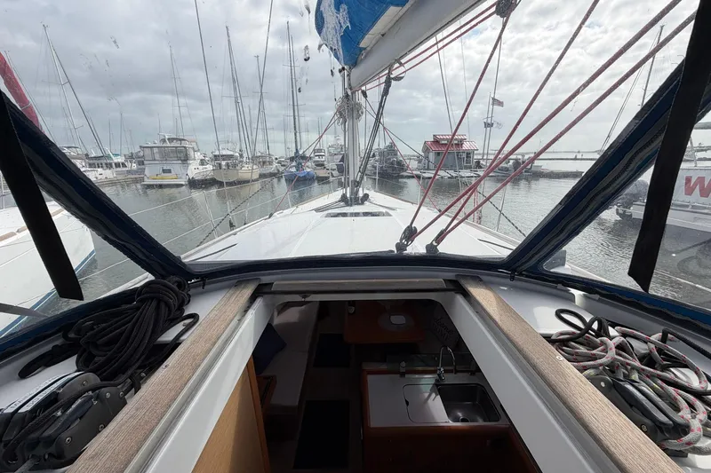Slide: The Image of 2018 Jeanneau Sun Odyssey 389 sailboat docked in a marina, interior and deck view. - 27