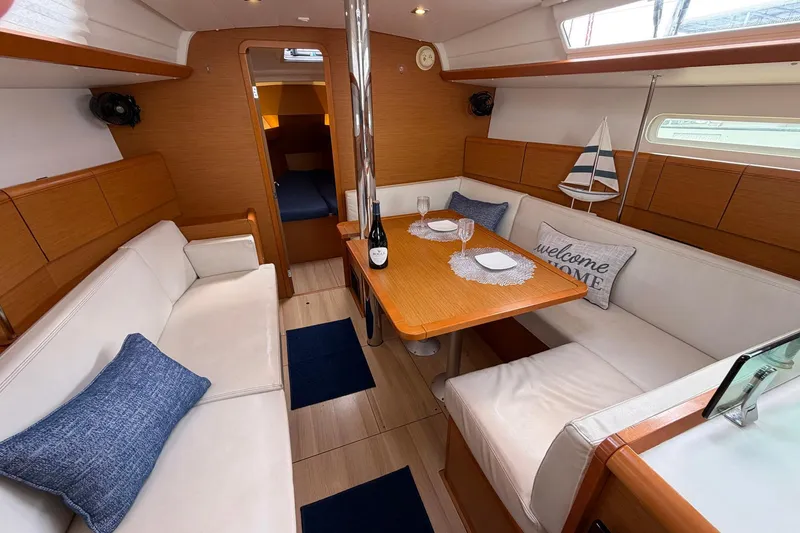 Slide: The Image of 2018 Jeanneau Sun Odyssey 389 interior with cozy seating and dining area. - 29