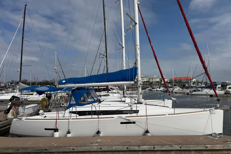 Slide: The Image of 2018 Jeanneau Sun Odyssey 389 sailboat docked in a marina under a blue sky. - 3