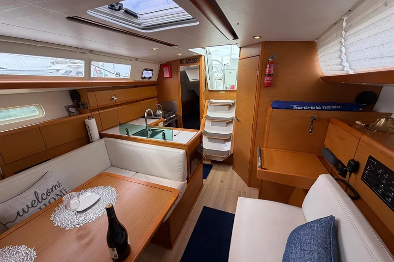 Slide: The Image of Interior of 2018 Jeanneau Sun Odyssey 389 yacht with modern furnishings and cozy seating. - 31