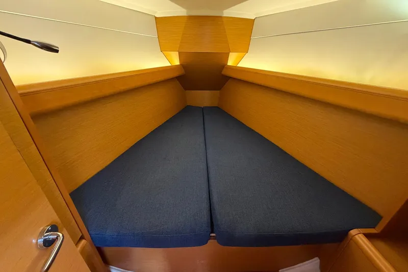 Slide: The Image of Cozy cabin interior of 2018 Jeanneau Sun Odyssey 389 sailboat with blue cushions. - 37
