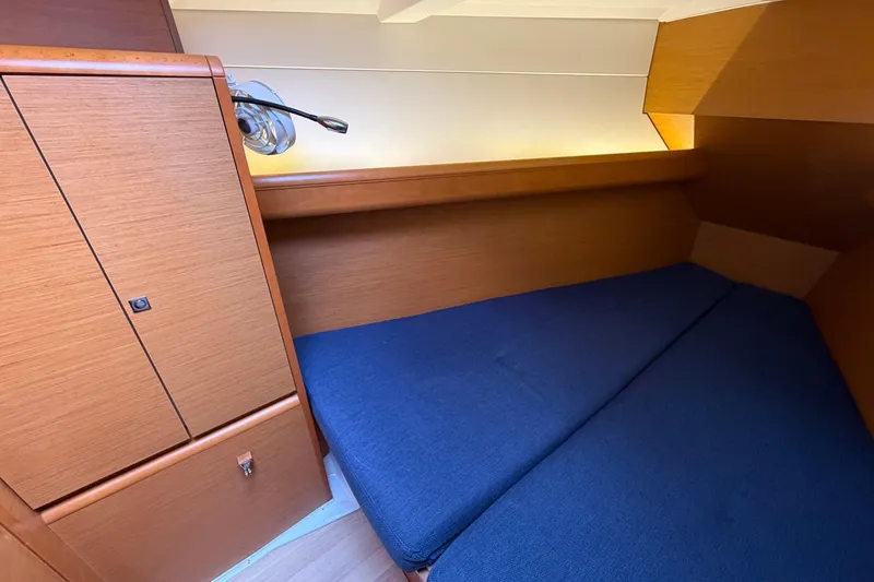 Slide: The Image of Cozy cabin interior of 2018 Jeanneau Sun Odyssey 389 sailboat with blue bedding. - 39