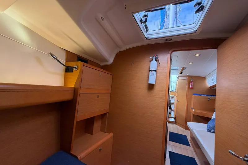 Slide: The Image of Interior of 2018 Jeanneau Sun Odyssey 389 sailboat, featuring wood cabinetry and seating. - 40