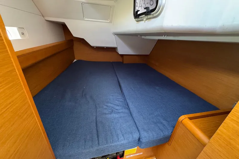 Slide: The Image of Cozy cabin interior of 2018 Jeanneau Sun Odyssey 389 sailboat with blue bedding. - 42