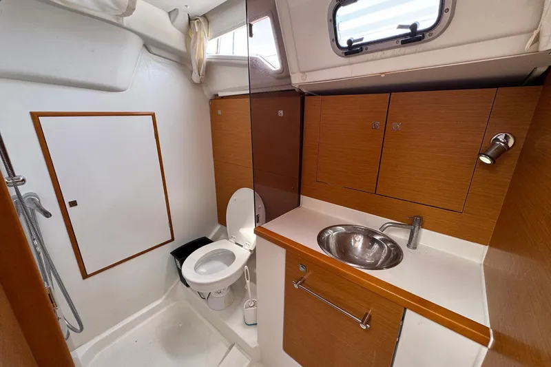 Slide: The Image of 2018 Jeanneau Sun Odyssey 389 bathroom with sink, toilet, and wooden cabinetry. - 43