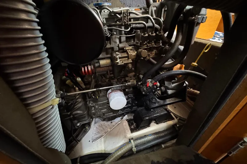 Slide: The Image of Engine compartment of 2018 Jeanneau Sun Odyssey 389 sailboat, showcasing mechanical components and hoses. - 50