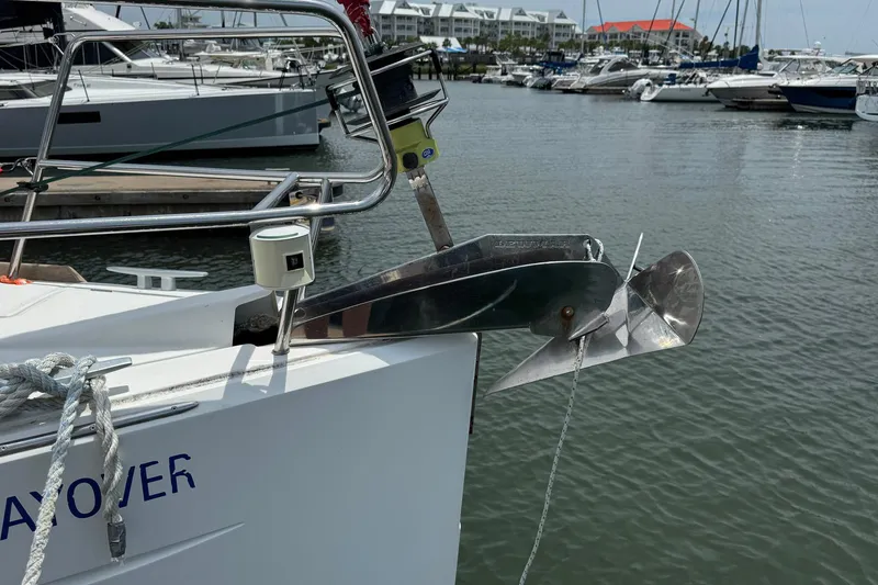 Slide: The Image of Jeanneau Sun Odyssey 389 (2018) anchored at marina, showcasing bow and anchor detail. - 9