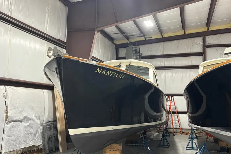 The Image of 2004 Hinckley 36 Picnic Boat EP in storage, showcasing sleek design and craftsmanship. - 1