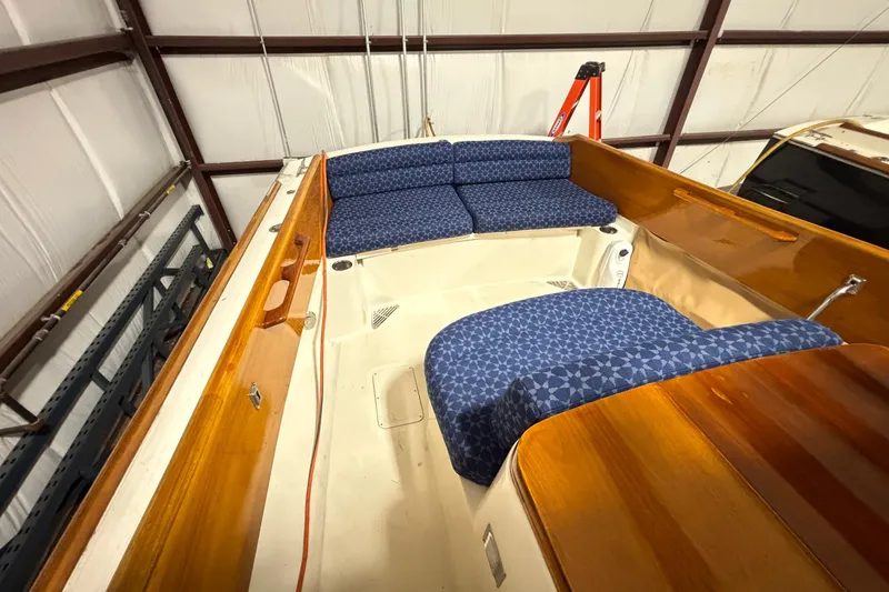 Slide: The Image of Interior of a 2004 Hinckley 36 Picnic Boat EP with blue patterned seating. - 11