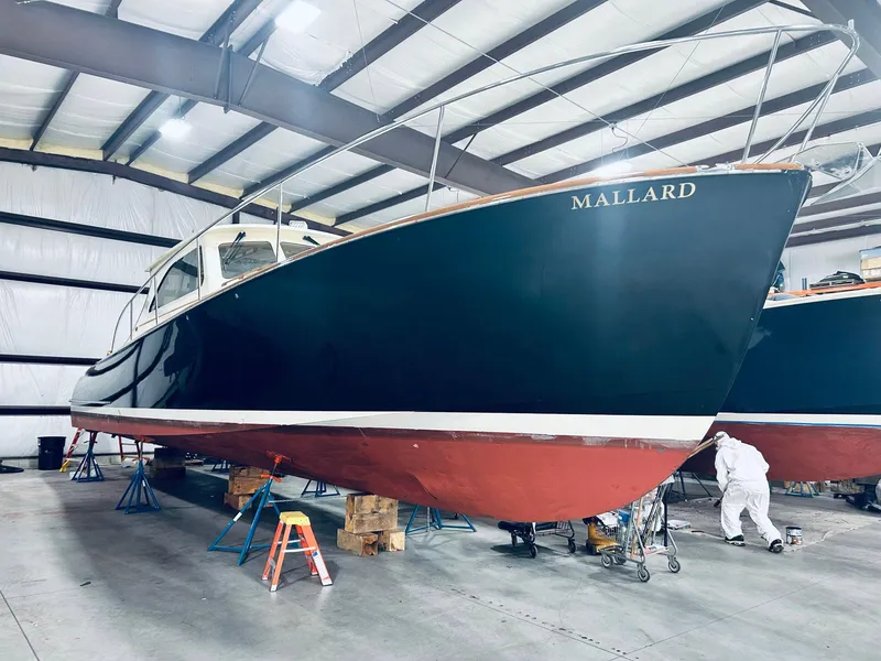 Slide: The Image of 2005 Hinckley Talaria 44 MY yacht in a warehouse, undergoing maintenance. - 1