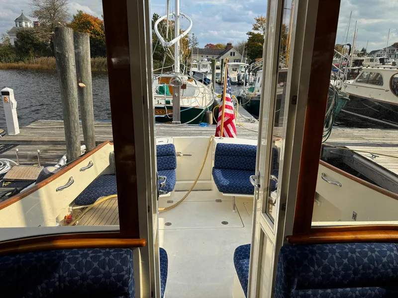 Slide: The Image of Hinckley Talaria 44 MY 2005 yacht interior with blue seating, docked at a marina. - 18
